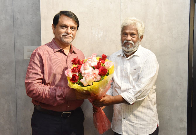 Employees congratulate Arvind Kumar on his promotion