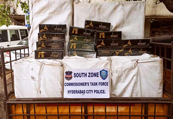 policemen holding paris cigarettes in hyderabad