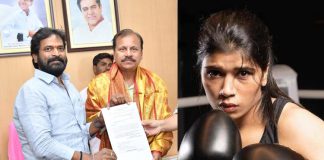 Srinivas Goud gives plot paper to Nikhat Zareen