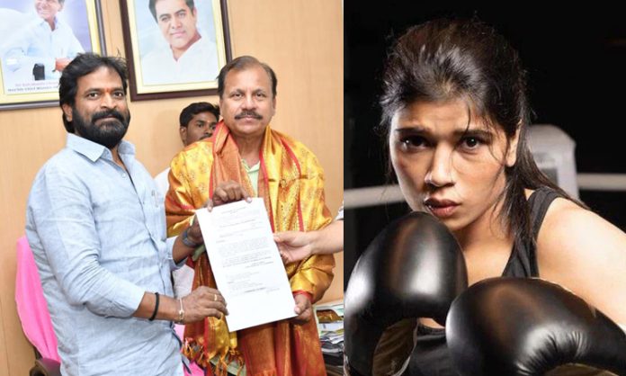 Srinivas Goud gives plot paper to Nikhat Zareen