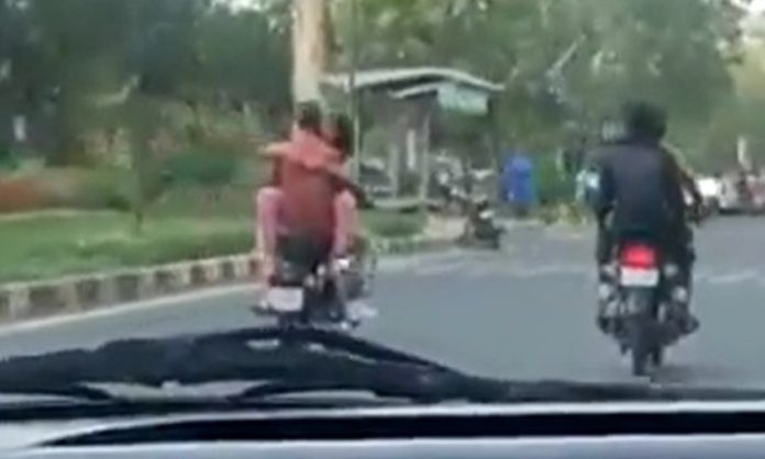 Jaipur couple hugging each other on motorcycle