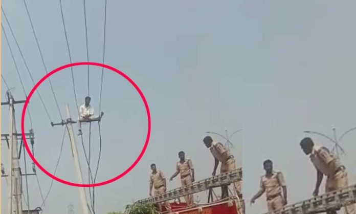man climbs current pole in Medak