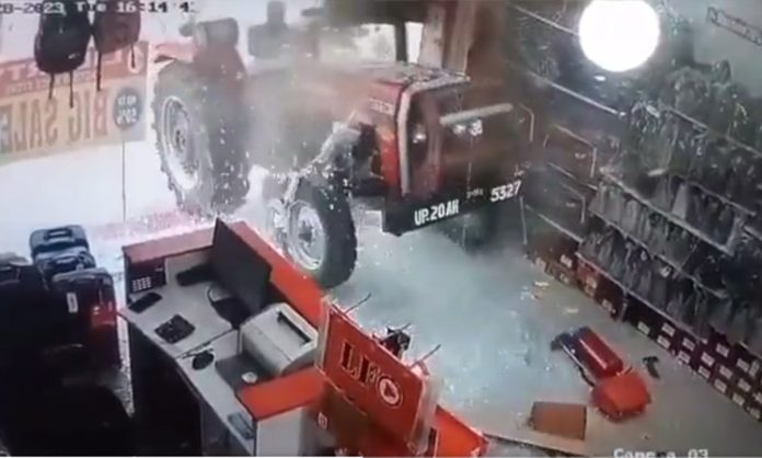 Tractor enters shop breaking glass door