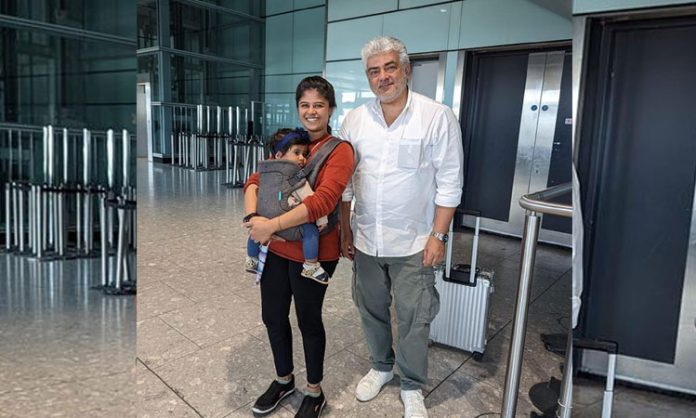 Ajith carrying baby and mother's bag
