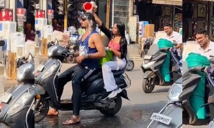 Young couple bathing on scooter