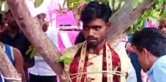 Groom tied to a tree by bride's family
