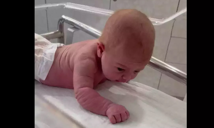 Infant crawling on bed