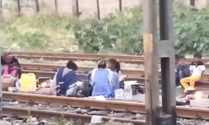 People Cooking Food On Train Tracks Near Mumbai