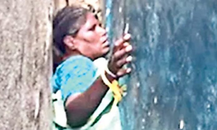 Old woman trapped between walls
